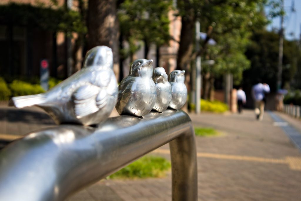 Little metal birds on a railing